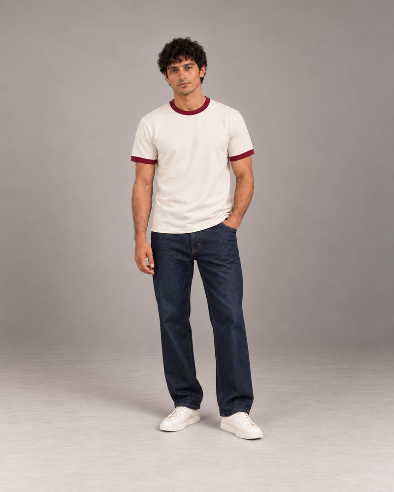 Front view of The Just Adulting Club cream relaxed fit ringer T-shirt with burgundy crewneck and sleeve trims, styled with dark denim.